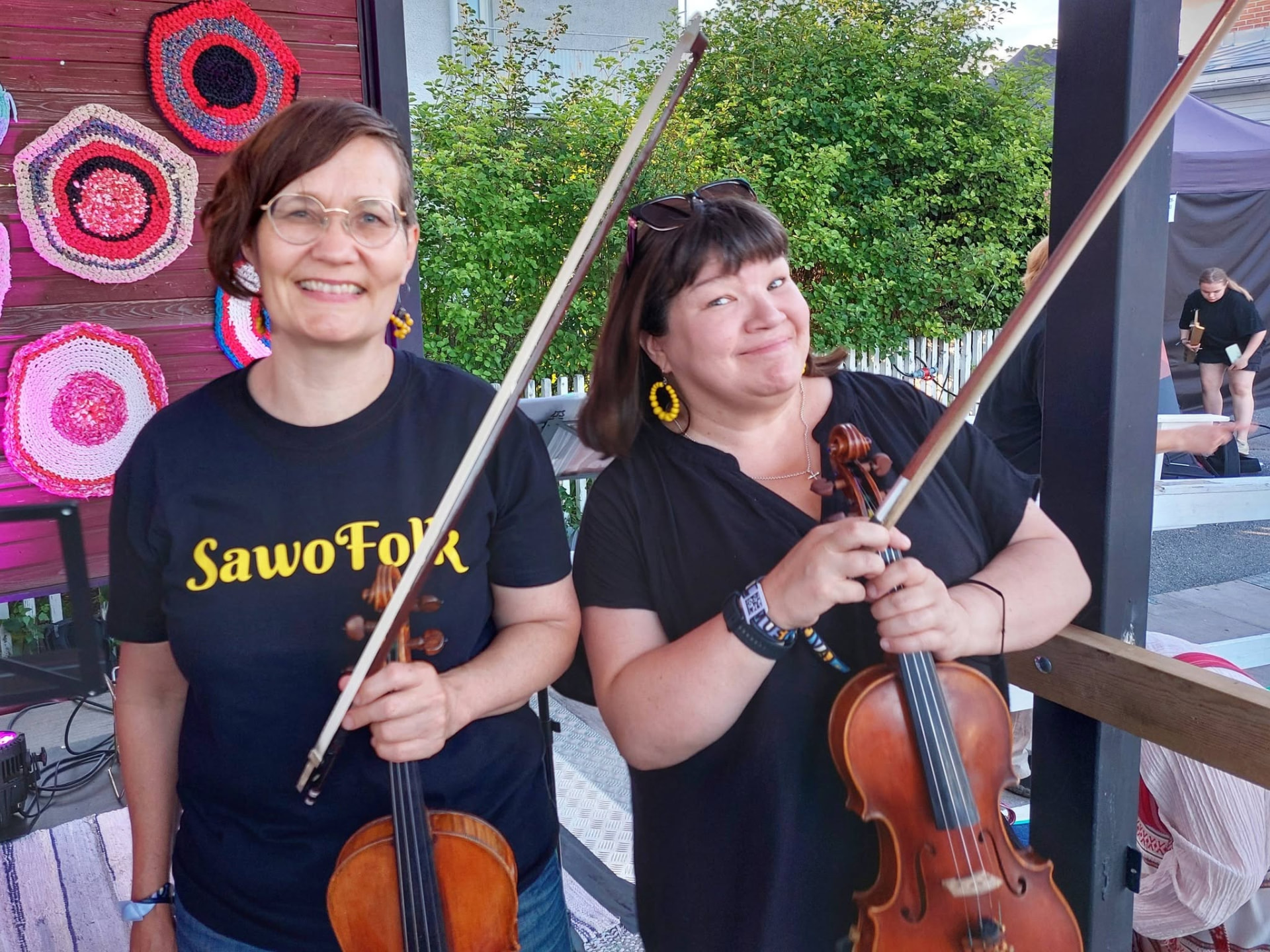 Two fiddlers smiling